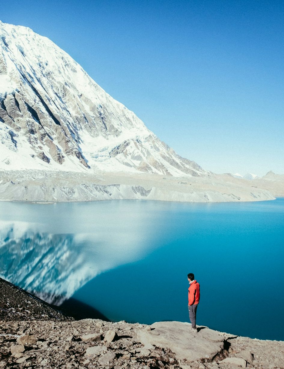 Trekker at Tilicho Lake in the Annapurna region of Nepal